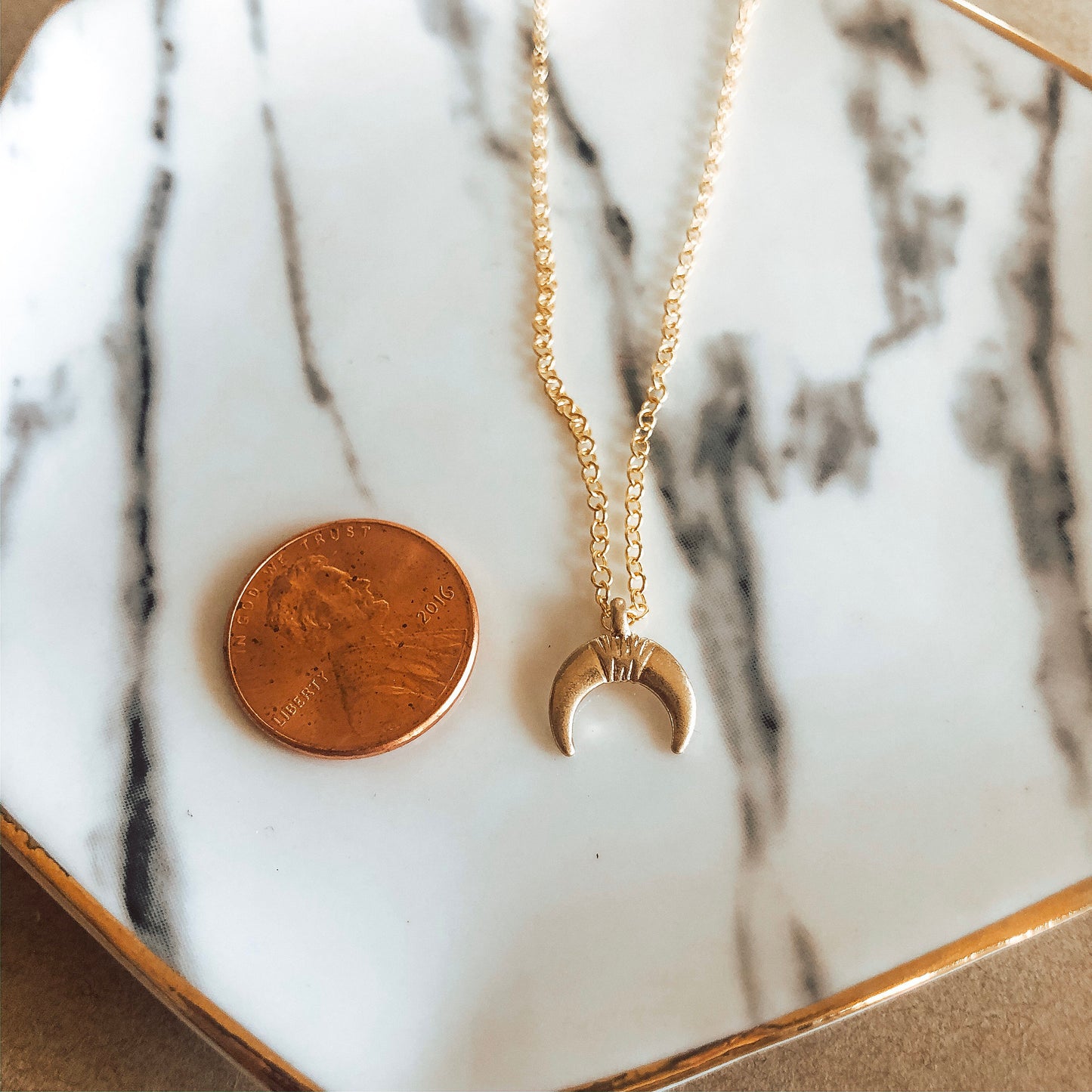 Gold crescent charm necklace